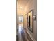 Hallway leading to bathroom featuring wood flooring, a mirror, and a view of the tub at 5685 Lake Victoria Dr, Lakeland, FL 33813