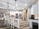 Open kitchen with stainless steel appliances, white cabinetry, and an island with bar seating at 5685 Lake Victoria Dr, Lakeland, FL 33813