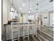 Bright kitchen featuring a breakfast bar with pendant lights, white cabinetry, and stainless steel appliances at 5685 Lake Victoria Dr, Lakeland, FL 33813