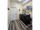 Functional laundry room equipped with modern black washer and dryer units and ample shelving at 5685 Lake Victoria Dr, Lakeland, FL 33813