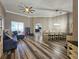 Spacious living and dining area with wood-look floors, crown molding and large windows at 5685 Lake Victoria Dr, Lakeland, FL 33813