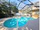 Outdoor pool area with screened enclosure, deck, and well-maintained landscaping at 5685 Lake Victoria Dr, Lakeland, FL 33813