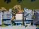 Aerial view of a home with a flat roof, surrounding houses and the lake at 616 Peninsular Dr, Lakeland, FL 33813