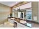 Modern bathroom with dual sinks, granite counters, large mirror and a view to the outside through a window at 616 Peninsular Dr, Lakeland, FL 33813