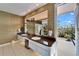 Bright bathroom featuring double vanities, tile floors, and a walk out balcony at 616 Peninsular Dr, Lakeland, FL 33813