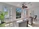 Cozy bedroom with plantation shutters, neutral paint, ceiling fan and a seating area at 616 Peninsular Dr, Lakeland, FL 33813