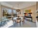 Bright dining area featuring a glass table, modern lighting, and serene views from large windows at 616 Peninsular Dr, Lakeland, FL 33813