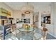 Elegant dining room featuring a glass table, modern lighting, and view of kitchen and living spaces at 616 Peninsular Dr, Lakeland, FL 33813
