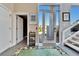 Bright entryway featuring a patterned rug, unique decor, and a staircase with glass panels at 616 Peninsular Dr, Lakeland, FL 33813