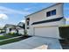 Modern exterior showcasing a two-car garage, contemporary design, and a well-kept lawn at 616 Peninsular Dr, Lakeland, FL 33813