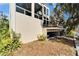 Back of house with a covered patio area and stairs leading to the upper level at 616 Peninsular Dr, Lakeland, FL 33813