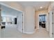 Hallway leading to a living room and office space, with neutral colors and carpet flooring at 616 Peninsular Dr, Lakeland, FL 33813