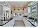 Modern kitchen with white cabinets, black countertops, pendant lights, and scenic window view at 616 Peninsular Dr, Lakeland, FL 33813