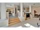 Open concept living room featuring wood stairs, neutral paint, carpet, and columns at 616 Peninsular Dr, Lakeland, FL 33813