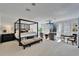 Spacious main bedroom with a four-poster bed, sitting area, and plantation shutters at 616 Peninsular Dr, Lakeland, FL 33813
