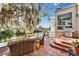 Outdoor patio area with wicker furniture, overlooking a tranquil lake, perfect for relaxation and entertaining at 616 Peninsular Dr, Lakeland, FL 33813