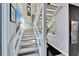 Bright staircase featuring white railings, natural light, and modern design elements at 616 Peninsular Dr, Lakeland, FL 33813