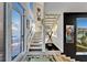 Open concept staircase with modern railings, gallery wall, and a view of the outdoors at 616 Peninsular Dr, Lakeland, FL 33813