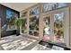 Bright sunroom featuring large windows, a plant, black flooring, and scenic views at 616 Peninsular Dr, Lakeland, FL 33813