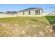 Exterior view of home with screened patio and fenced backyard at 456 Hilltop Dr, Lake Wales, FL 33853