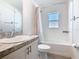 Bright bathroom with white cabinets, modern sink, and shower over the tub at 456 Hilltop Dr, Lake Wales, FL 33853