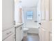Bright bathroom with white cabinets, modern sink, and shower over the tub at 456 Hilltop Dr, Lake Wales, FL 33853
