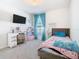 Charming bedroom with plush carpet, modern TV, and bright window at 456 Hilltop Dr, Lake Wales, FL 33853