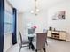 Bright dining area features a glass table, modern chandelier, and access to the backyard at 456 Hilltop Dr, Lake Wales, FL 33853