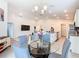 Open-concept dining area features a modern chandelier and leads into a living room and kitchen at 456 Hilltop Dr, Lake Wales, FL 33853