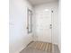 Bright entryway with white walls, vinyl floor and a mirror on the coat closet door at 456 Hilltop Dr, Lake Wales, FL 33853