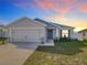 Charming single-story home with a two-car garage, landscaped front yard, and neutral color palette at 456 Hilltop Dr, Lake Wales, FL 33853