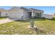Well-maintained front yard featuring an agave plant centered in a circular stone bed at 456 Hilltop Dr, Lake Wales, FL 33853