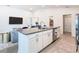 Open kitchen with a center island, stainless steel appliances, and adjacent dining area at 456 Hilltop Dr, Lake Wales, FL 33853