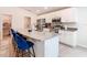 Contemporary kitchen featuring a large island with seating, stainless appliances, and white cabinets at 456 Hilltop Dr, Lake Wales, FL 33853