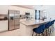 Modern kitchen with stainless steel appliances, white cabinetry, and a breakfast bar with seating at 456 Hilltop Dr, Lake Wales, FL 33853