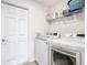 Bright laundry room with modern washer and dryer and ample shelving at 456 Hilltop Dr, Lake Wales, FL 33853