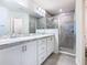 Spacious main bathroom boasts double sinks, granite countertops, and a glass-enclosed shower at 456 Hilltop Dr, Lake Wales, FL 33853