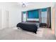 The main bedroom features an accent wall, carpet floors, and ensuite bathroom at 456 Hilltop Dr, Lake Wales, FL 33853