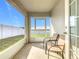 Screened patio with chairs and view of the backyard at 456 Hilltop Dr, Lake Wales, FL 33853