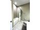 Bathroom featuring white tiled shower, a white toilet, and tiled floors at 648 Bloom Ter, Davenport, FL 33836
