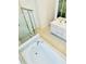 Bright bathroom with a soaking tub and walk-in shower for a spa-like experience at 648 Bloom Ter, Davenport, FL 33836