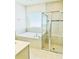 Bathroom featuring a soaking tub and separate glass shower, creating a luxurious retreat at 648 Bloom Ter, Davenport, FL 33836