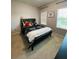 Cozy bedroom with a decorative headboard bed, natural light, and soft carpet at 648 Bloom Ter, Davenport, FL 33836