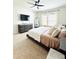 Cozy bedroom with a large dresser, stylish decor, and comfortable furnishings at 648 Bloom Ter, Davenport, FL 33836