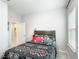 Cozy bedroom featuring a patterned quilt and a window for natural light at 648 Bloom Ter, Davenport, FL 33836