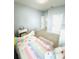 Cozy bedroom featuring a colorful bedspread, carpeted floors, and natural light at 648 Bloom Ter, Davenport, FL 33836