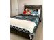 Comfortable bedroom featuring a dark bed frame and colorful bedding near a window at 648 Bloom Ter, Davenport, FL 33836