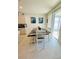 Bright dining room with modern table, chairs, and bench seating, adjacent to sliding glass doors at 648 Bloom Ter, Davenport, FL 33836
