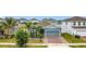 Charming single-Gathering home with a well-manicured lawn, palm trees, and a brick driveway at 648 Bloom Ter, Davenport, FL 33836