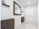 Inviting foyer featuring a large mirror, storage unit, and tile flooring near the entrance at 648 Bloom Ter, Davenport, FL 33836